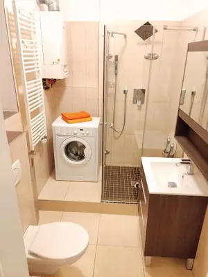 a bathroom with a washing machine and a shower at Apartment Žižkov in Prague
