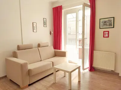 a living room with a couch and a table at Apartment Žižkov in Prague