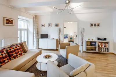 a living room with a couch and chairs and a table at Residence Vinohrad in Prague