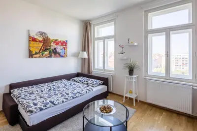 a living room with a bed and a table at Residence Vinohrad in Prague