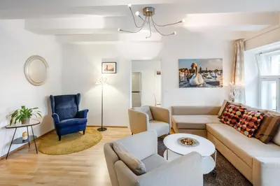 a living room with a couch and a chair at Residence Vinohrad in Prague