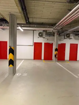 an empty parking lot with red lockers in a garage at Studio Mozart, Free Onsite Parking, Air Conditioning, 1Gbs WiFi in Prague