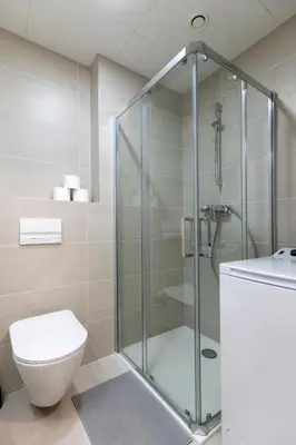 a bathroom with a toilet and a glass shower at Studio Mozart, Free Onsite Parking, Air Conditioning, 1Gbs WiFi in Prague