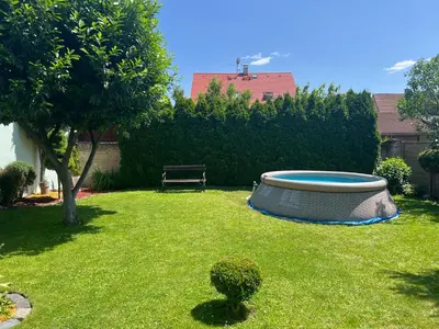 a backyard with a tub in the grass at Family House in Spa Town Podebrady with Garden in Poděbrady