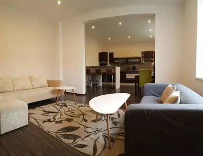 a living room with a couch and a table at Family House in Spa Town Podebrady with Garden in Poděbrady