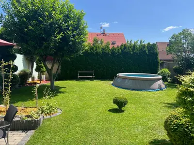 a garden with a tub in the grass at Family House in Spa Town Podebrady with Garden in Poděbrady