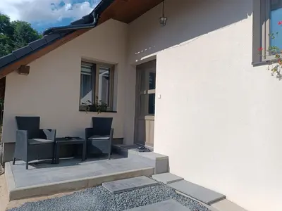 a patio of a house with two chairs and a table at Apartmán Pod Hrází Chráštany in Benešov