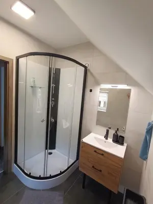 a bathroom with a shower and a sink at Apartmán Pod Hrází Chráštany in Benešov