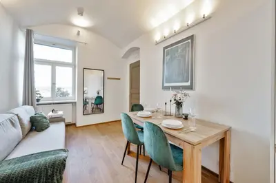 a living room with a table and a couch at Elegant Apartments close to Center & Bike Path in Prague