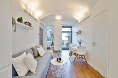 a living room with a couch and a table at Elegant Apartments close to Center & Bike Path in Prague