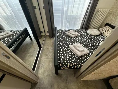 a small bed in a room with a window at GeraStay Sokolska in Prague