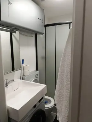 a bathroom with a white sink and a toilet at GeraStay Sokolska in Prague