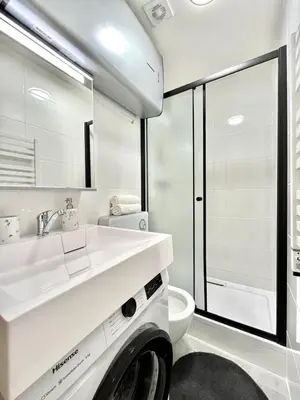 a bathroom with a white sink and a toilet at GeraStay Sokolska in Prague