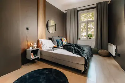 a bedroom with a bed and a window at Cinema Apartment Billiard & Foosball - City Centre in Prague