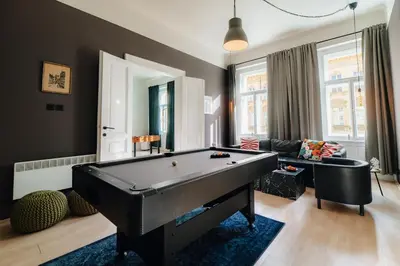 a living room with a pool table in it at Cinema Apartment Billiard & Foosball - City Centre in Prague
