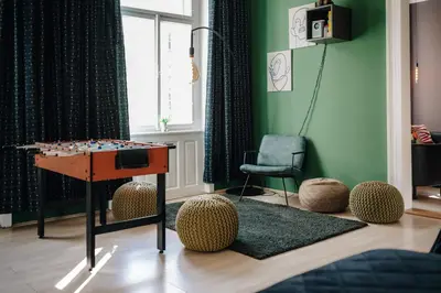 a room with a desk and a chair and a table at Cinema Apartment Billiard & Foosball - City Centre in Prague