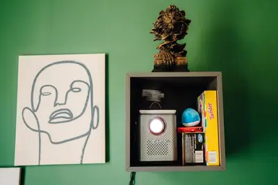 a shelf with a picture of a head and a candle at Cinema Apartment Billiard & Foosball - City Centre in Prague
