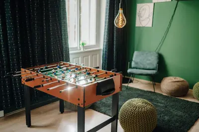 a large foosball table in a room with a chair at Cinema Apartment Billiard & Foosball - City Centre in Prague