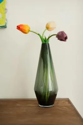 a vase with flowers in it sitting on a table at Artisan & Old-timey 2 bedrooms home in Prague