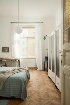 a bedroom with a bed and a large window at Artisan & Old-timey 2 bedrooms home in Prague