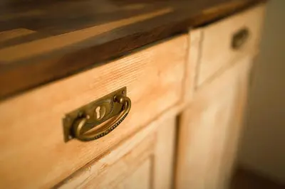 a wooden drawer with a brass drawer pull on it at Artisan & Old-timey 2 bedrooms home in Prague