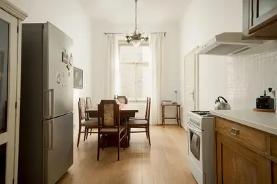 a kitchen and dining room with a table and refrigerator at Artisan & Old-timey 2 bedrooms home in Prague