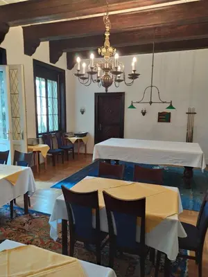 a dining room with tables and chairs and a chandelier at Hotel Sanssouci in Prague
