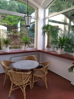 a table and chairs in a room with windows at Hotel Sanssouci in Prague