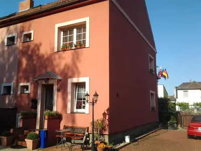 a red building with a table and a window at Pension Villa Marit in Prague