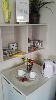 a kitchen counter with plates and a toaster on it at Pension Villa Marit in Prague