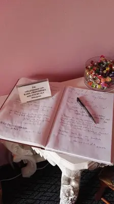 a book with a note and a pen on a table at Pension Villa Marit in Prague