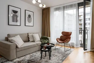 a living room with a couch and a chair at Prague Days - One-bedroom Apartment with Garage Parking and Balcony in Prague