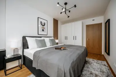 a bedroom with a large bed in a room at Prague Days - One-bedroom Apartment with Garage Parking and Balcony in Prague