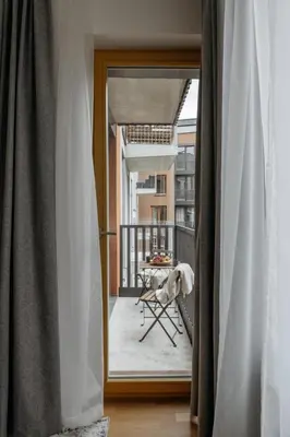 a view of a balcony from a room with a mirror at Prague Days - One-bedroom Apartment with Garage Parking and Balcony in Prague