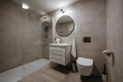 a bathroom with a sink and a toilet and a mirror at Prague Days - One-bedroom Apartment with Garage Parking and Balcony in Prague