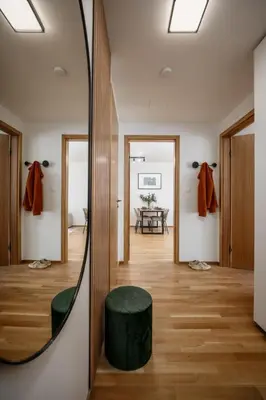 a room with a mirror and a green stool at Prague Days - One-bedroom Apartment with Garage Parking and Balcony in Prague