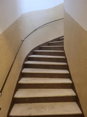 a staircase in a building with a stair railing at Komárov Apartment 2 in Komárov