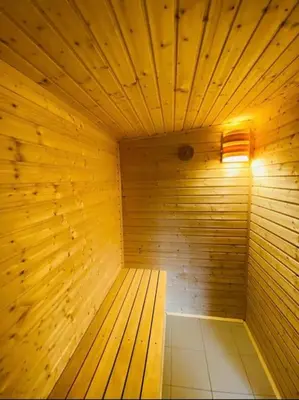 a wooden sauna with a light on top of it at Glamping paradise with wellness in Dolní Břežany