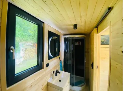 a bathroom with a sink and a window and a toilet at Glamping paradise with wellness in Dolní Břežany