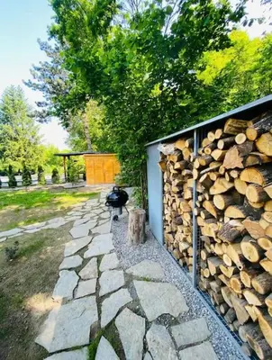 a pile of fire wood next to a wall at Glamping paradise with wellness in Dolní Břežany