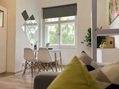 a living room with a table and chairs at STYLISH FLAT IN PRAGUE - Vinohrady in Prague
