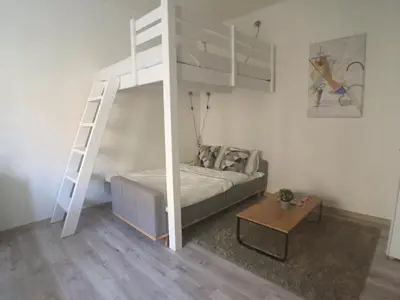 a bedroom with a bunk bed and a ladder at STYLISH FLAT IN PRAGUE - Vinohrady in Prague