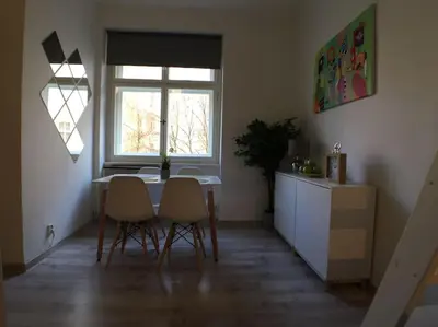 a kitchen with a table and chairs and a window at STYLISH FLAT IN PRAGUE - Vinohrady in Prague
