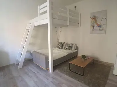 a bedroom with a bunk bed and a ladder at STYLISH FLAT IN PRAGUE - Vinohrady in Prague