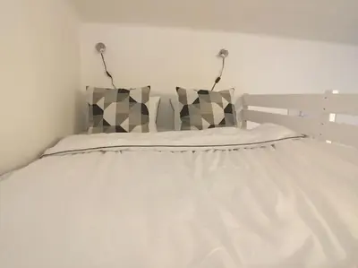 a white bed with two pillows on top of it at STYLISH FLAT IN PRAGUE - Vinohrady in Prague