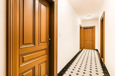 a hallway with a door and a checkered floor at Apartment Linda Prague in Prague