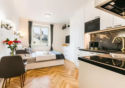 a kitchen with a desk and a bed in a room at Apartment Linda Prague in Prague