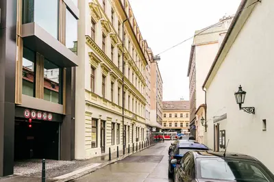 a city street with parked cars and buildings at Apartment Linda Prague in Prague