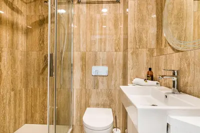 a bathroom with a toilet and a sink and a shower at Apartment Linda Prague in Prague