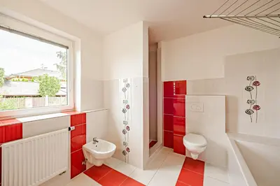 a bathroom with a toilet and a sink and a window at U tří koček in Herink